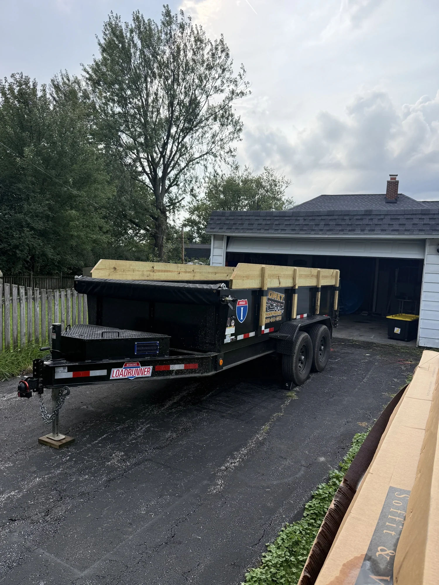 DMKT Disposal dump trailer parked on a residential driveway in Northeast Ohio